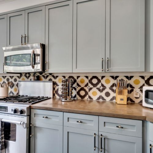 A bold, patterned tile backsplash featuring black