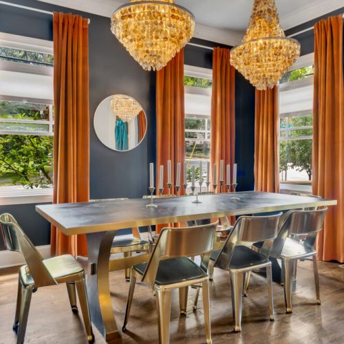 Two crystal chandeliers and sleek gold chairs make every meal feel like a celebration.