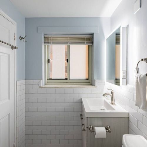 The upper half of the walls is painted a soft, light blue or sky blue color