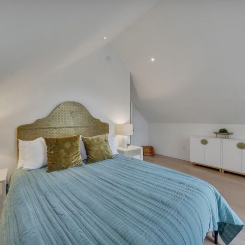 , Bright bedroom with wooden headboard