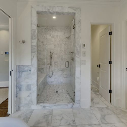 Bathroom 1 - Floor to ceiling marbled tile shower area