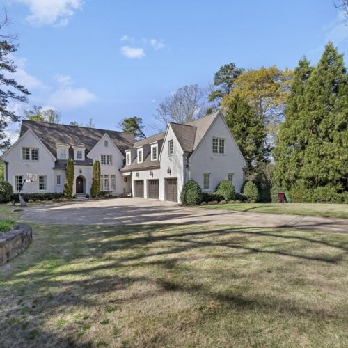 Charming home exterior w/ spacious driveway & manicured lawn welcoming you in
