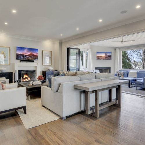 Spacious living room w/ sectional seating & wide windows overlooking outdoors