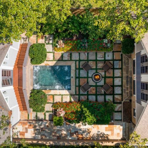 Overhead view of courtyard w/ geometric layout & central fire feature
