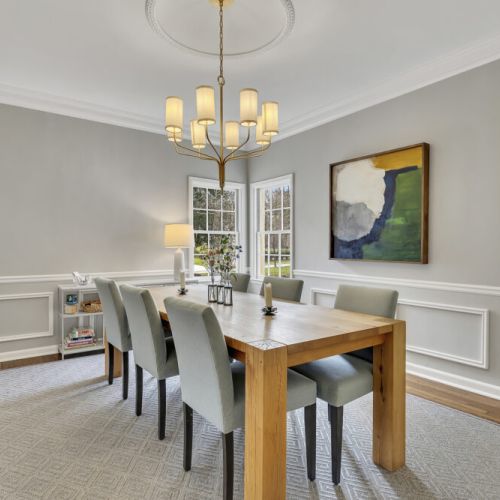 Dining table set for gatherings under a stylish chandelier