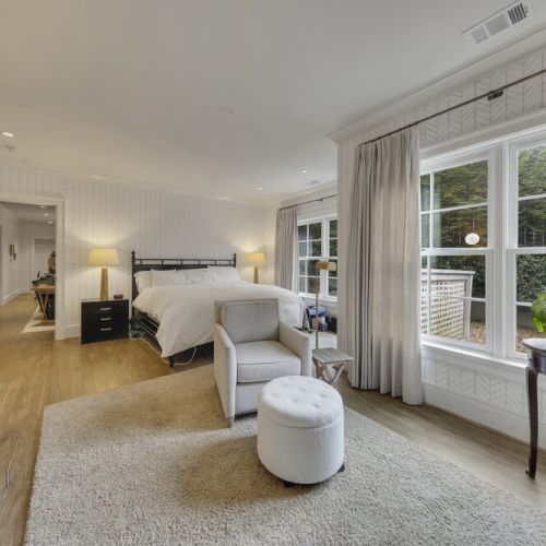 Bedroom 5 - Large windows offering peaceful natural views and soft light.