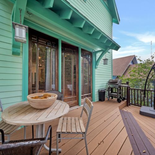 The deck is enclosed by a matching wood railing in the same dark brown tone