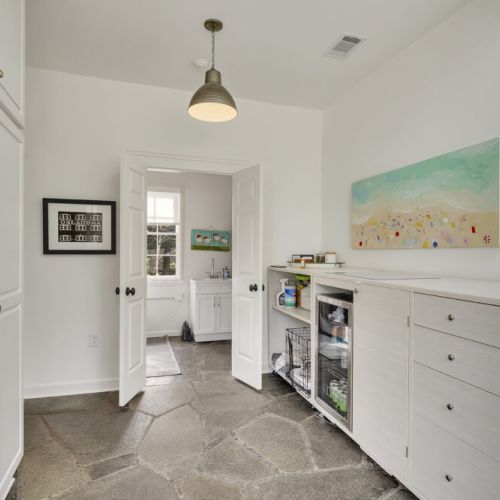 Functional laundry room w/ storage & workspace for daily tasks