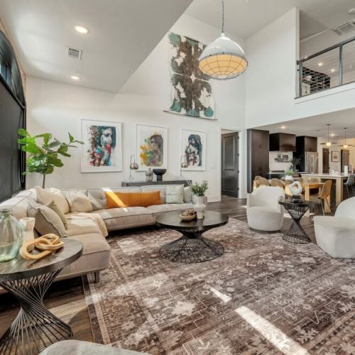 Bright living room w/ high ceilings, cozy sofa & open flow to kitchen