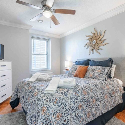 Queen bed with a ceiling fan