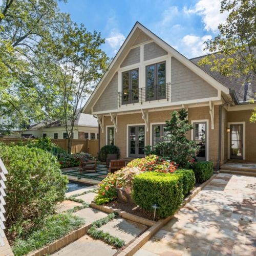 Manicured landscaping w/ hedges creating a sense of privacy