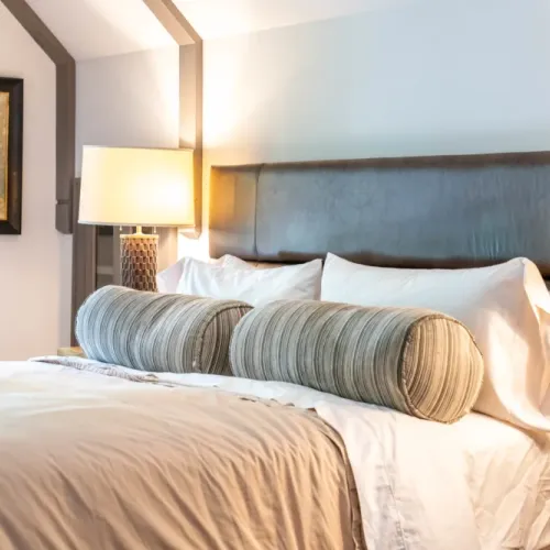 Serene bedroom w/ upholstered bed & soft, layered bedding