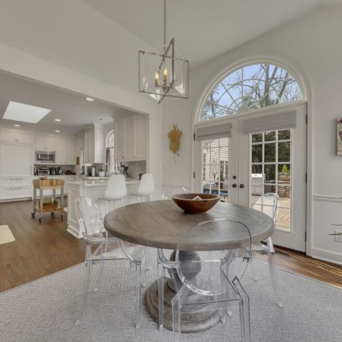 Dining space w/ backyard & pool views through large windows