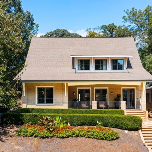 Professionally landscaped front yard with manicured hedges