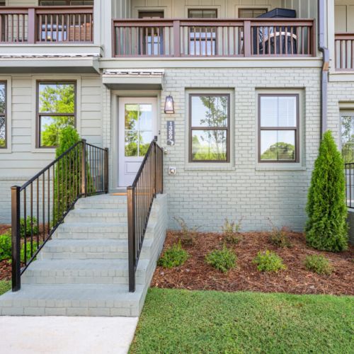 Welcome to the property! The private front entrance features a landscaped yard, brick steps, and a secure railing leading directly to the home. The well-maintained exterior gives guests a warm and inviting arrival.