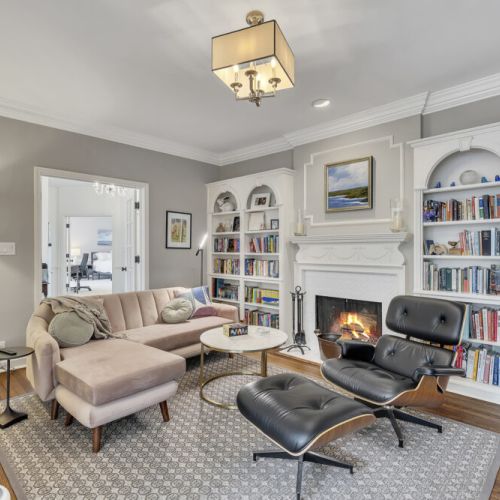 Lounge area w/ built-in shelving & inviting seating arrangement