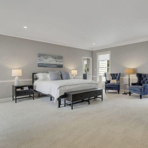 Expansive bedroom layout w/ sitting area & cozy accent chairs