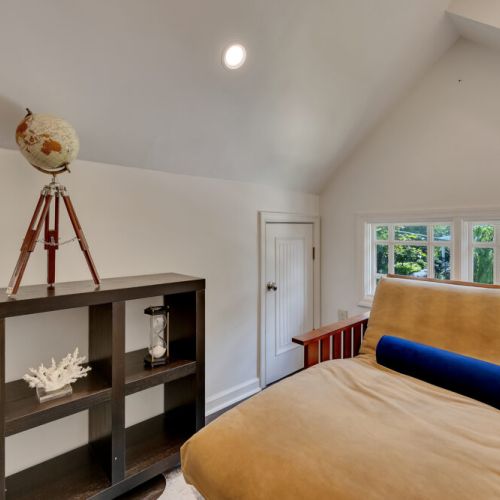 leading to a bright, finished loft space featuring a low-profile daybed