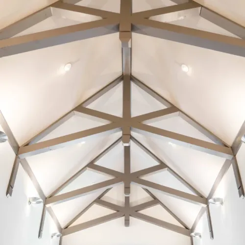 Striking vaulted ceiling w/ exposed beams adding architectural charm