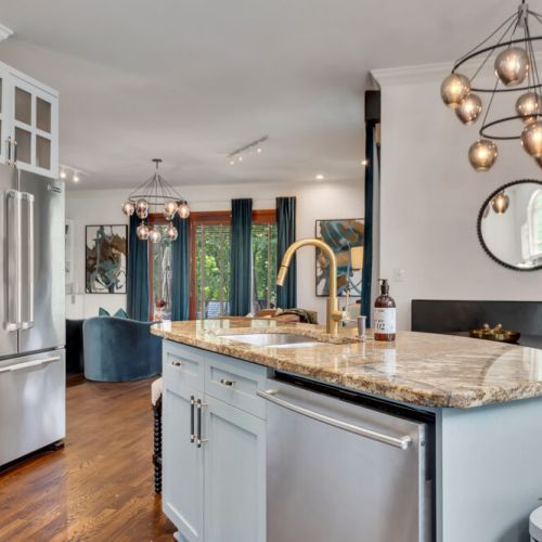 Breakfast nook goals! Seamless design flows from the built-in seating right into the modern, bright kitchen.