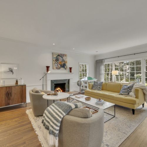 Bright living area w/ large windows, cozy seating & natural light throughout