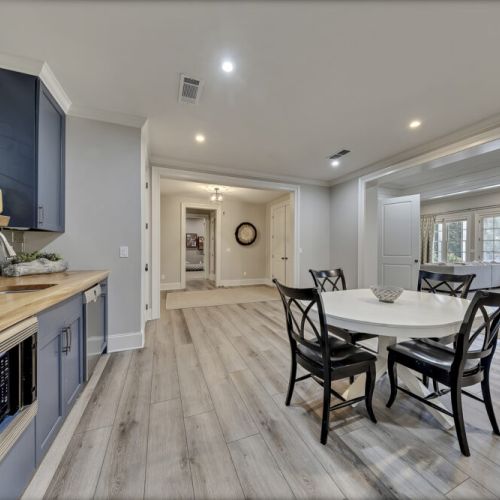 Lower level kitchen w/ dining table & open layout, perfect for casual meals together