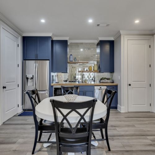 Inviting lower kitchen w/ blue cabinets & open shelving for added charm