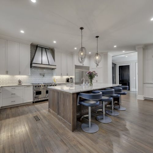 Modern kitchen w/ island seating & pendant lighting, ideal for cooking & conversation