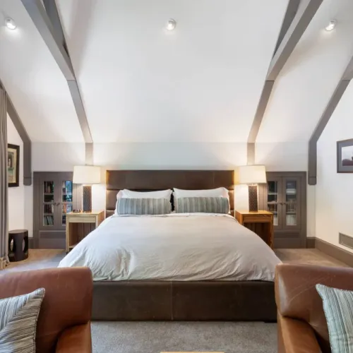 Spacious bedroom w/ bedside tables & warm ambient lighting