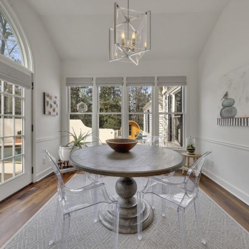 Sunlit dining nook w/ arched windows & inviting table for shared meals