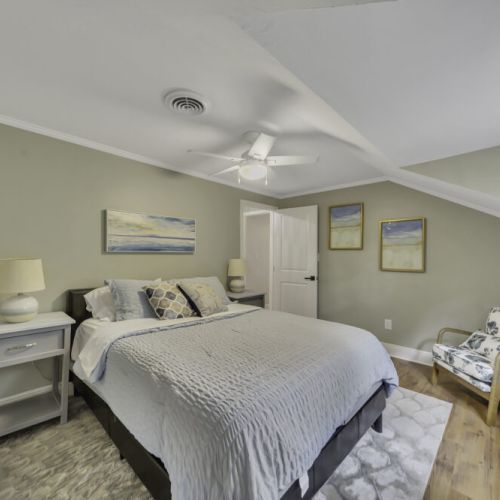 Comfortable queen-size bed with soft bedding and accent pillows