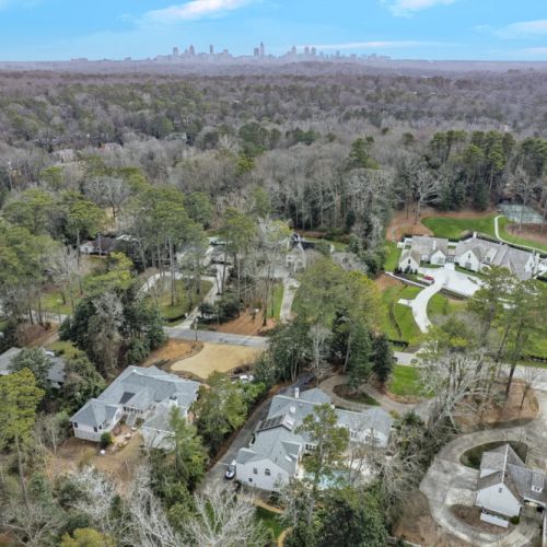 Scenic aerial view of lush surroundings & expansive property grounds