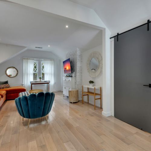 A bright and airy living area with a bold green velvet sofa
