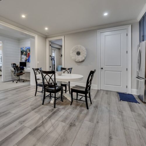 Lower level dining area w/ round table, ideal for relaxed group meals