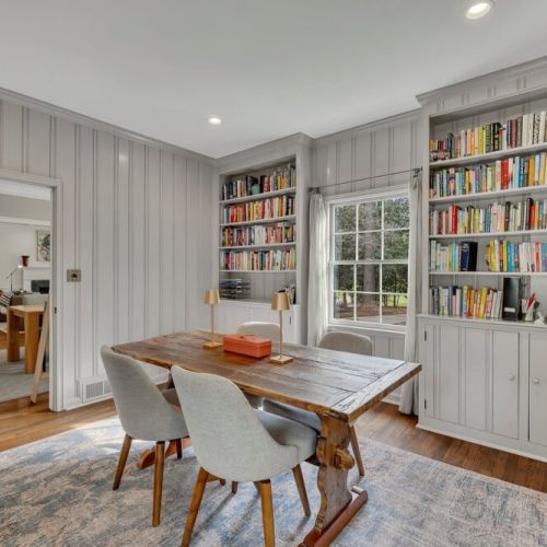 Wall-to-wall built-in bookshelves filled with curated reading selections