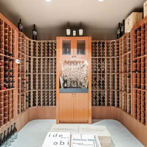 Impressive wine cellar w/ curved racks & extensive bottle storage