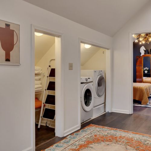 A highly functional hallway area featuring cleverly tucked-away amenities