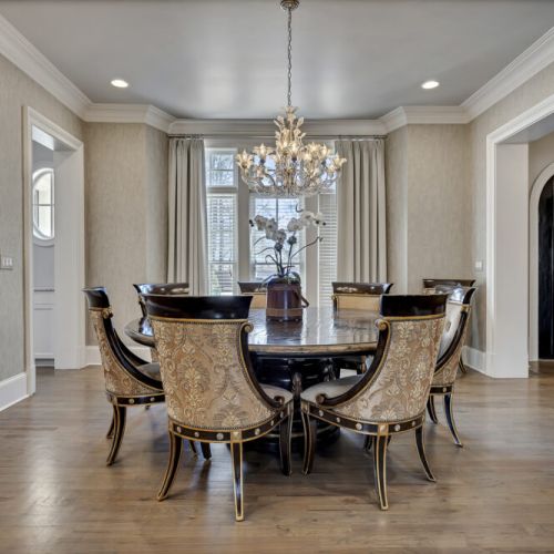 Elegant dining room w/ chandelier & round table, perfect for memorable gatherings