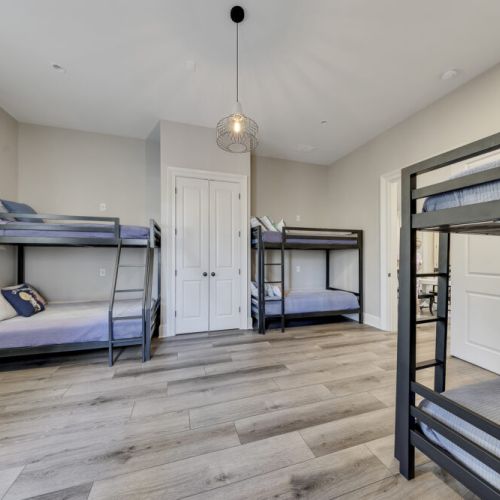Spacious bunk room w/ wood floors & natural light, great for kids or friends