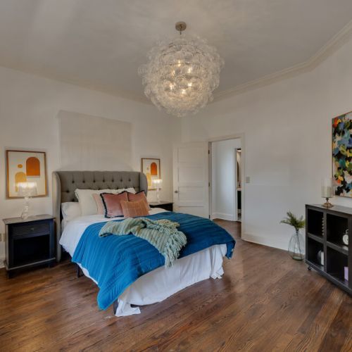 A sophisticated and vibrant bedroom featuring a modern bubble chandelier