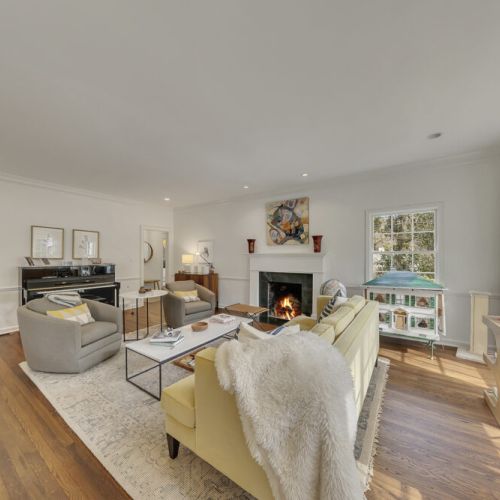Cozy seating area arranged around a fireplace for easy conversation