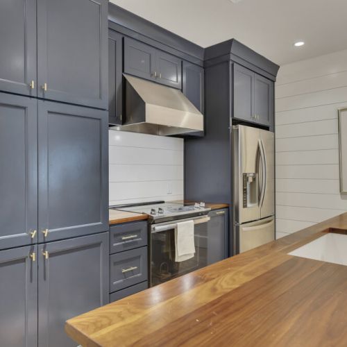 Basement Kitchen 2 -Premium navy cabinetry with gold hardware for a luxury feel