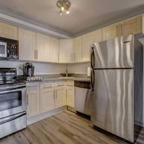 Fully equipped kitchen with stainless steel appliances.