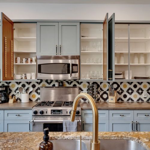 A central kitchen island with a matching light blue base holds the sink and provides counter space
