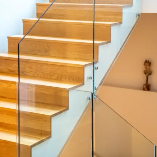 Glass railings paired w/ warm wood steps for a bright, airy feel
