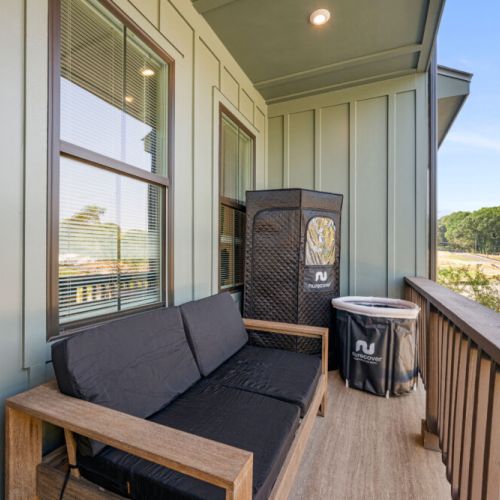 Relax on the private balcony with comfortable seating and a covered outdoor area. Enjoy fresh air and views of the surrounding neighborhood from this peaceful outdoor retreat.