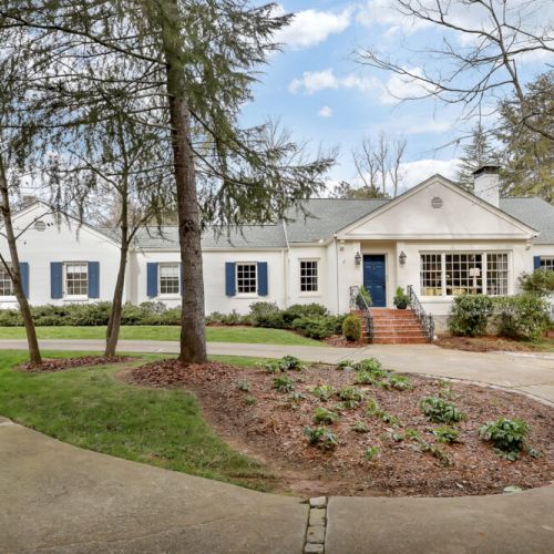 Welcoming home exterior w/ manicured landscaping & charming front entry
