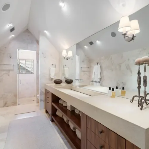 Spa-like bathroom w/ marble tile & a long double vanity