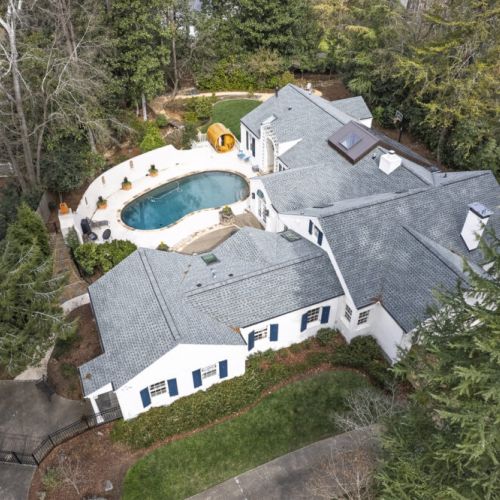 Aerial view showcasing the home’s layout & surrounding greenery