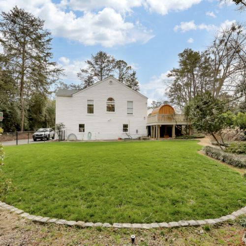 Expansive backyard w/ lush grass & serene wooded backdrop